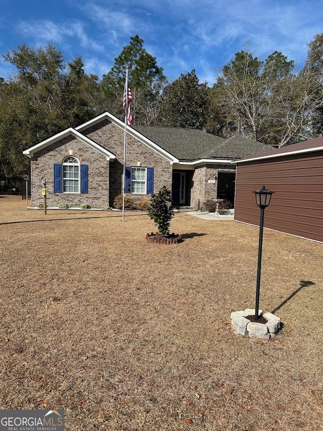 ranch-style home with a front yard