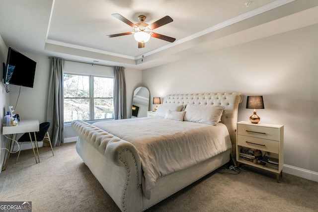 carpeted bedroom featuring ornamental molding, a raised ceiling, and ceiling fan