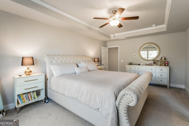 bedroom with crown molding, a tray ceiling, carpet floors, and ceiling fan