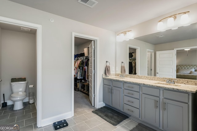 bathroom with vanity, tile patterned flooring, and toilet