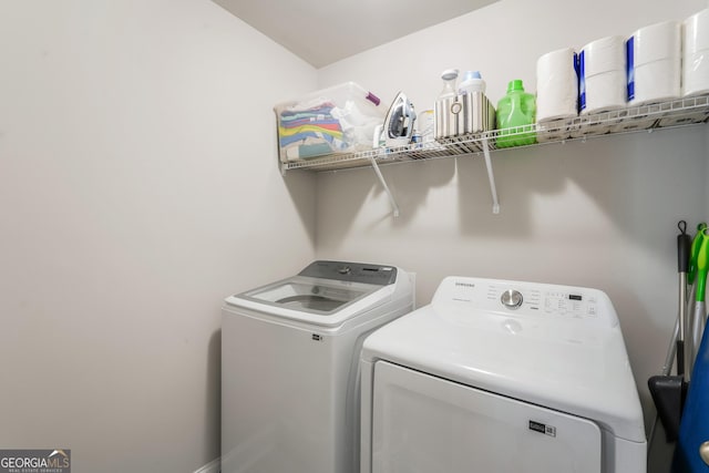 laundry room with washing machine and clothes dryer