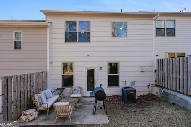 back of property with central AC, outdoor lounge area, and a patio