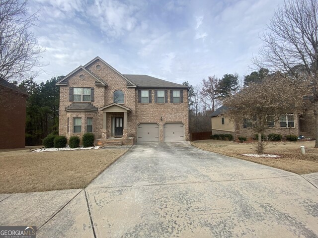 view of front of property featuring a garage and a front yard