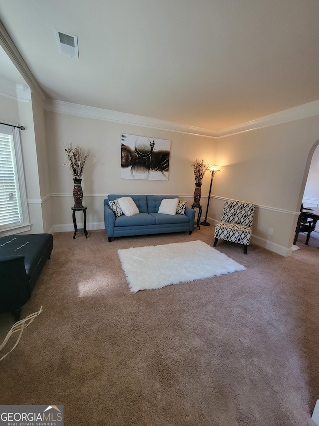 living room with crown molding and carpet floors