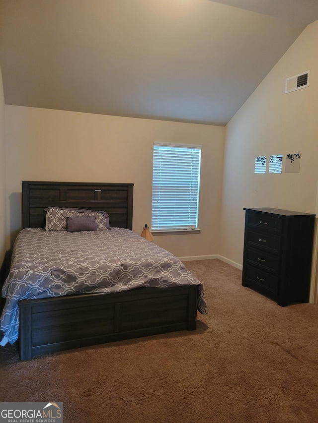 carpeted bedroom with lofted ceiling