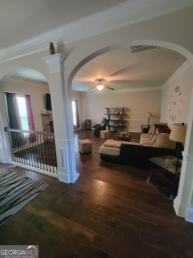 living room featuring crown molding, dark hardwood / wood-style floors, and ceiling fan