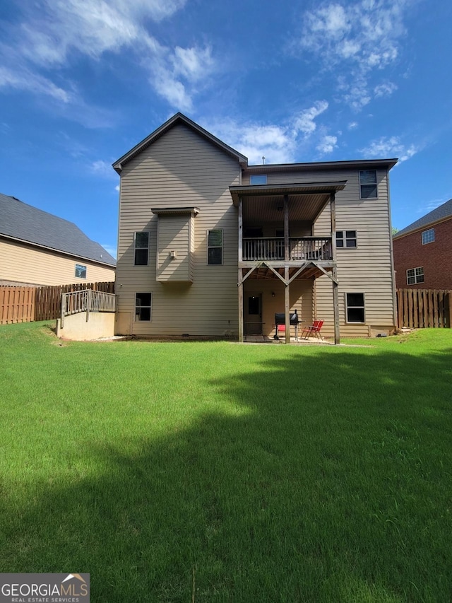 back of property featuring a lawn and a patio area