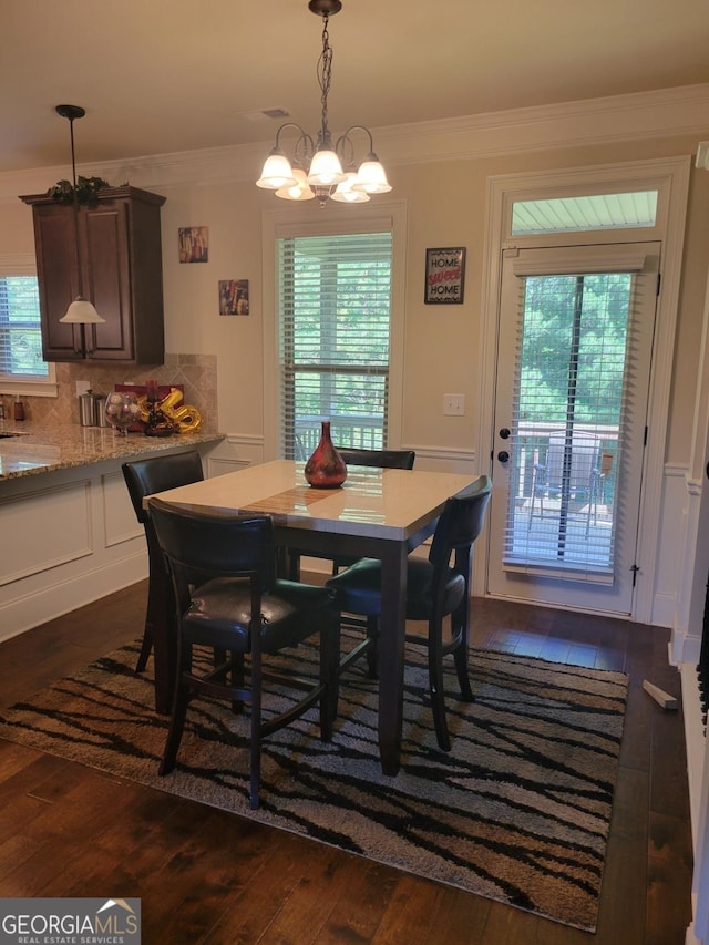 dining area featuring a wealth of natural light, dark wood-type flooring, and ornamental molding