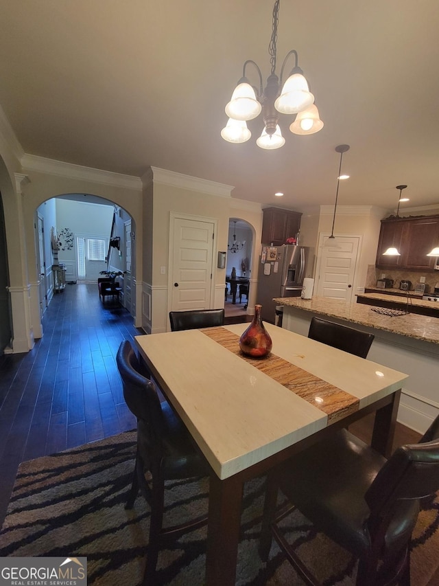 dining room with crown molding and dark hardwood / wood-style floors