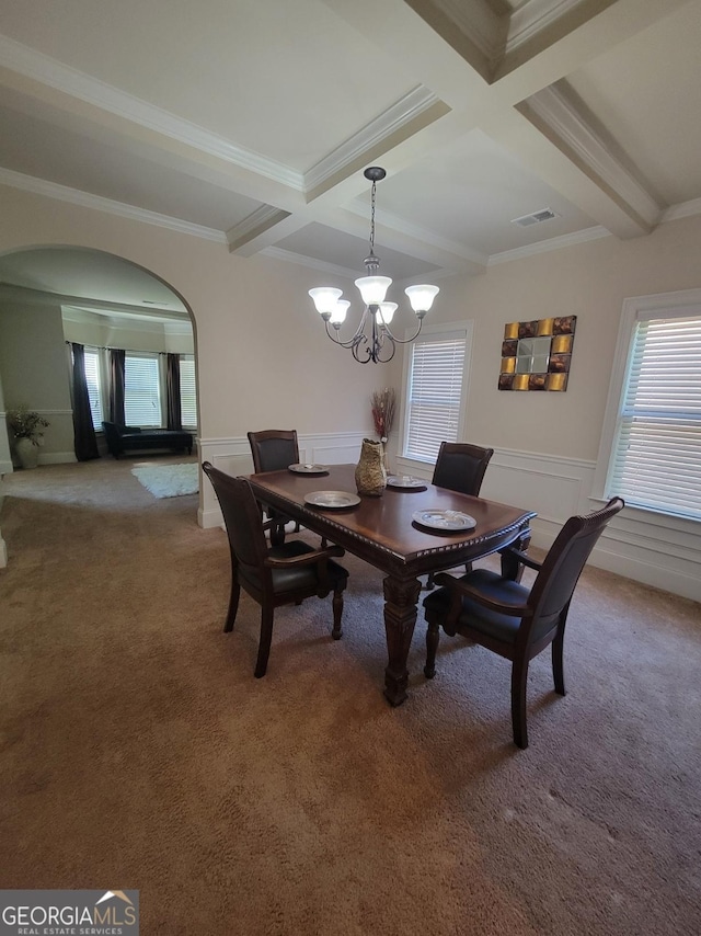 dining space featuring coffered ceiling, crown molding, a chandelier, carpet floors, and beamed ceiling