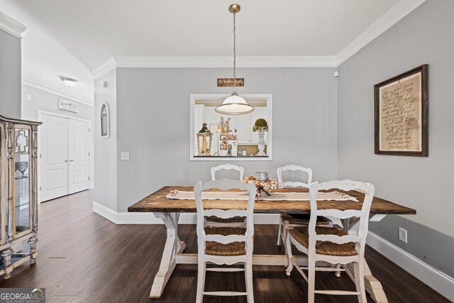 dining room with dark hardwood / wood-style flooring and ornamental molding