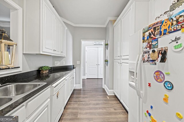 kitchen featuring dark hardwood / wood-style floors, white cabinetry, dark stone countertops, crown molding, and white appliances