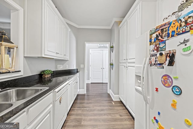 kitchen featuring wood finished floors, white appliances, white cabinets, and crown molding