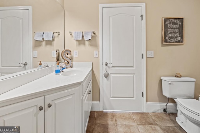 bathroom with tile patterned floors, vanity, and toilet