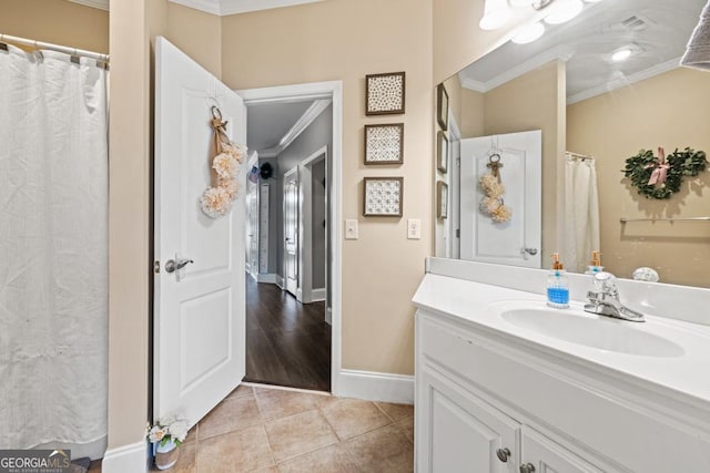 full bath featuring baseboards, ornamental molding, vanity, and tile patterned flooring