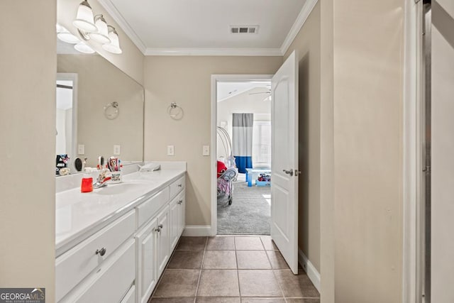 bathroom featuring tile patterned flooring, crown molding, and vanity