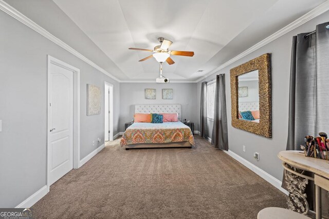 carpeted bedroom with a raised ceiling, ornamental molding, and ceiling fan