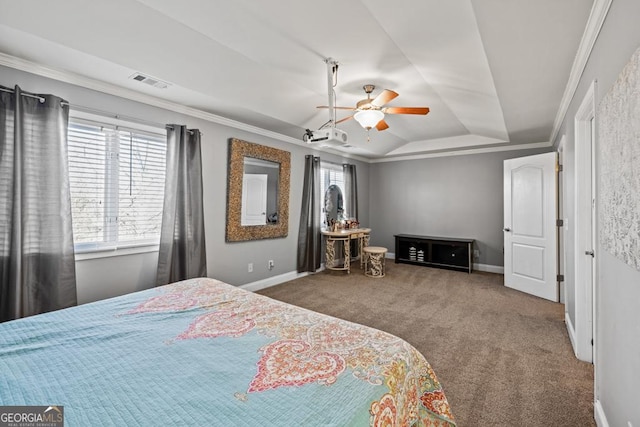 carpeted bedroom featuring multiple windows, crown molding, a tray ceiling, and ceiling fan