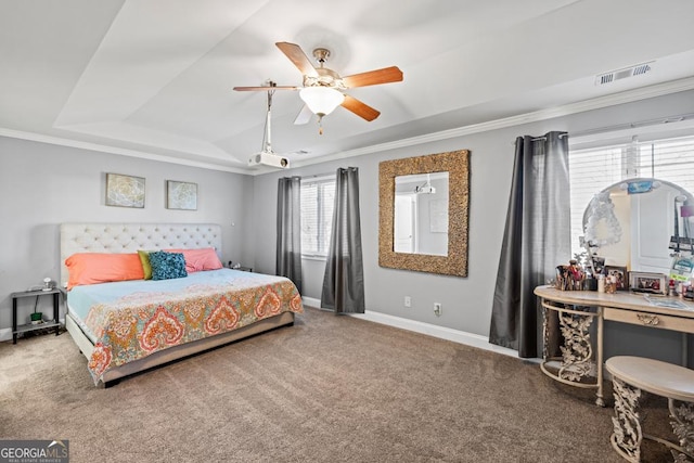 bedroom featuring ornamental molding, carpet, ceiling fan, and a tray ceiling