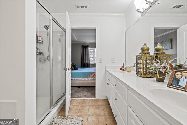 bathroom featuring tile patterned flooring, vanity, crown molding, and walk in shower