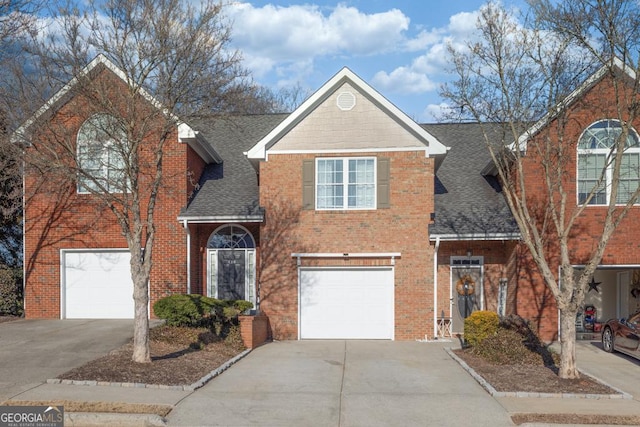 traditional home with brick siding, driveway, a shingled roof, and an attached garage