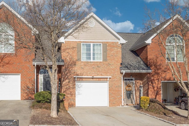 traditional-style home with a garage, brick siding, driveway, and roof with shingles