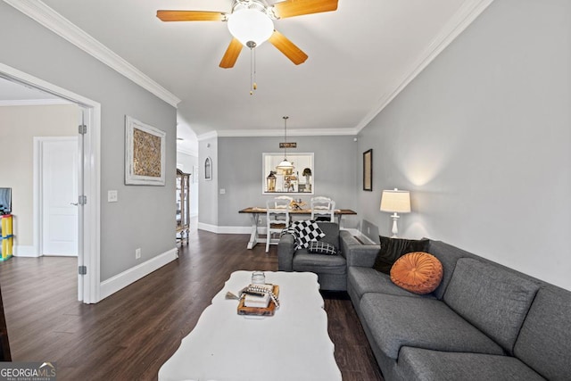 living room featuring dark wood-style floors, ceiling fan, baseboards, and ornamental molding