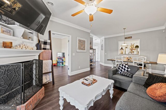 living room featuring crown molding, ceiling fan, and dark hardwood / wood-style flooring