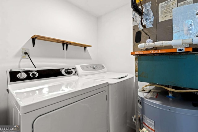 laundry room with washing machine and clothes dryer and water heater