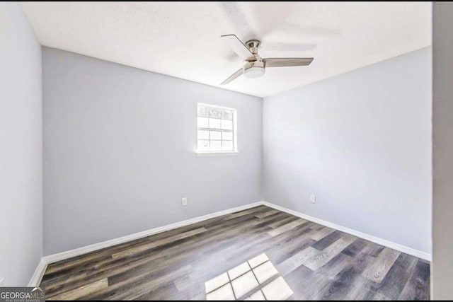 unfurnished room with ceiling fan and dark hardwood / wood-style floors