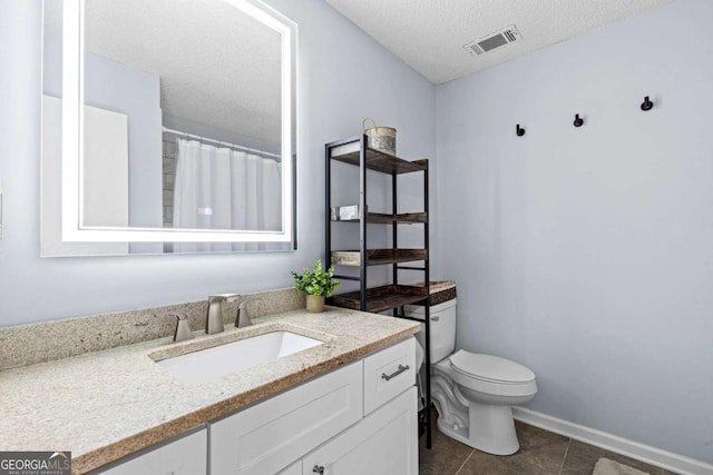 bathroom with tile patterned flooring, a shower with shower curtain, vanity, a textured ceiling, and toilet