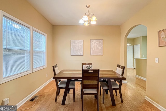 dining space featuring an inviting chandelier and light hardwood / wood-style floors