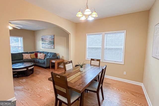 dining room with light hardwood / wood-style floors and a chandelier