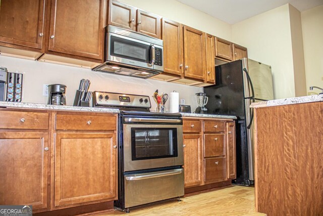 kitchen featuring stainless steel appliances and light hardwood / wood-style floors