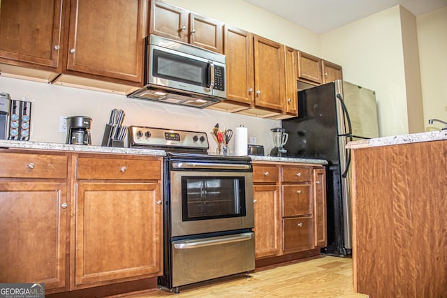 kitchen featuring stainless steel appliances and light wood-type flooring