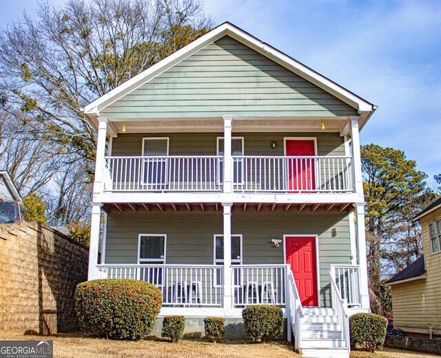 view of front of property featuring a porch and a balcony