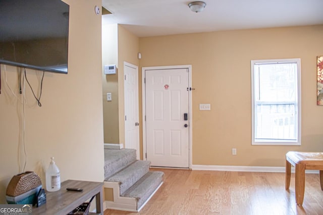 foyer entrance with light hardwood / wood-style floors