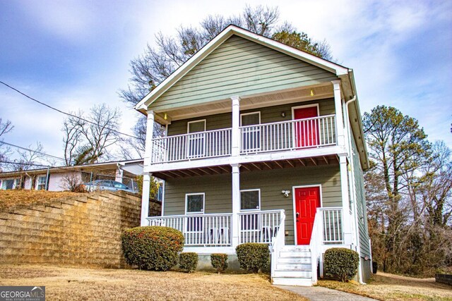 view of front of property with a porch and a balcony