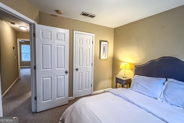 carpeted bedroom with a closet