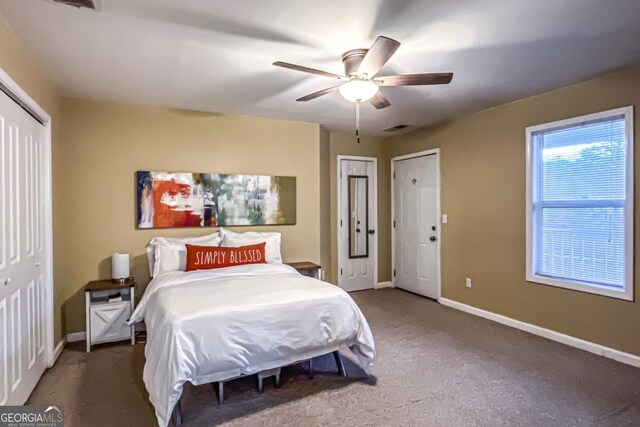 bedroom featuring dark carpet and ceiling fan