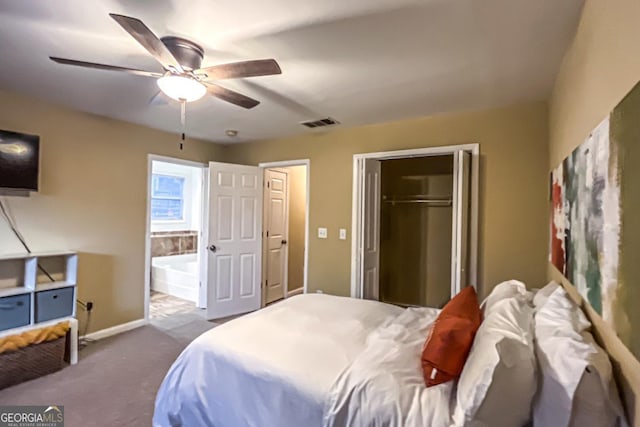 carpeted bedroom with ensuite bath, ceiling fan, and a closet