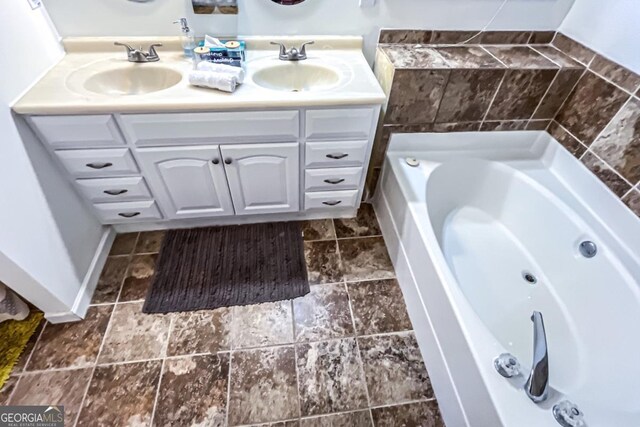 bathroom featuring vanity and a washtub