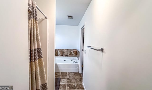 bathroom featuring separate shower and tub