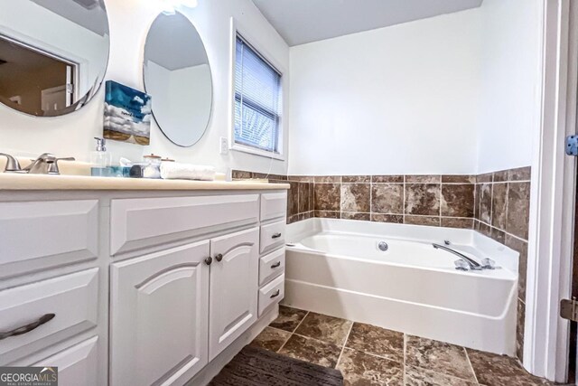 bathroom featuring vanity and a washtub