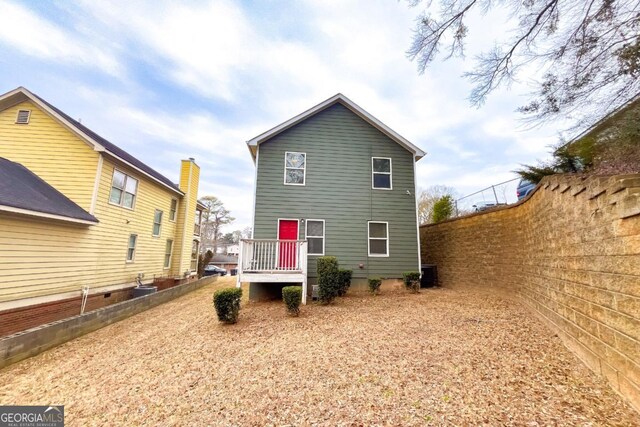 rear view of house featuring central AC unit