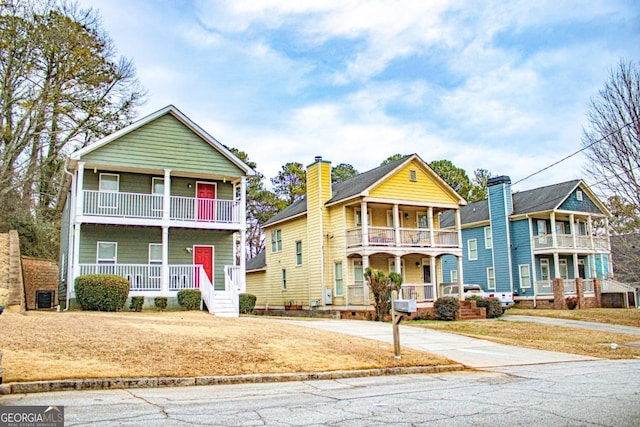 view of front of house with cooling unit, a balcony, and a porch