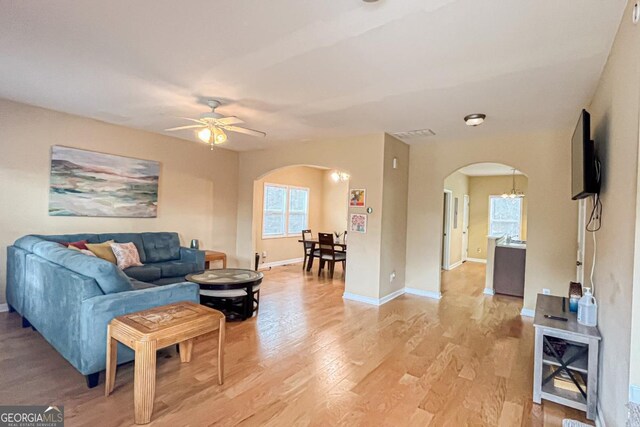 living room with light hardwood / wood-style floors and ceiling fan