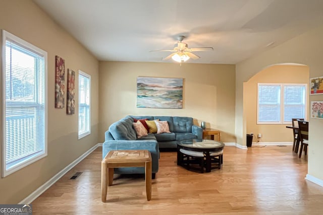 living room with ceiling fan and light hardwood / wood-style flooring