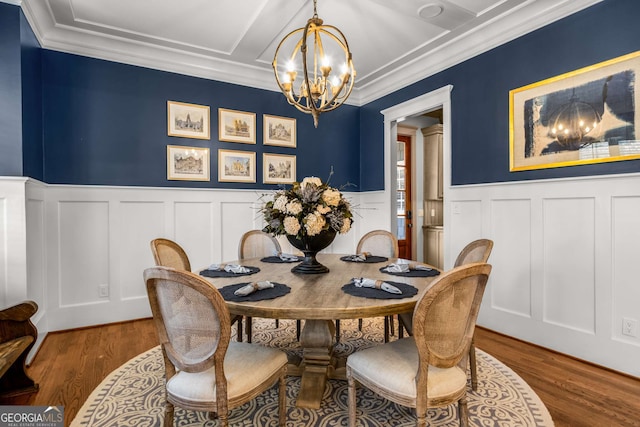 dining area with an inviting chandelier and hardwood / wood-style floors