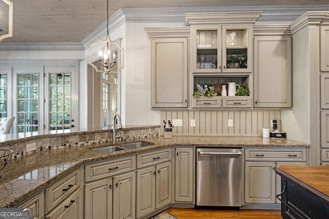 kitchen featuring sink, decorative light fixtures, dark stone countertops, ornamental molding, and dishwasher